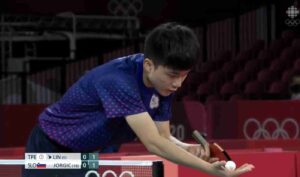 Lin Yun-Ju preparing for a serve at a table tennis service clinic, showcasing the precision and focus required for mastering the game. This image highlights the intensity and dedication of professional training, capturing a moment of concentration before the serve, with the essence of competitive play and skill development at the forefront.